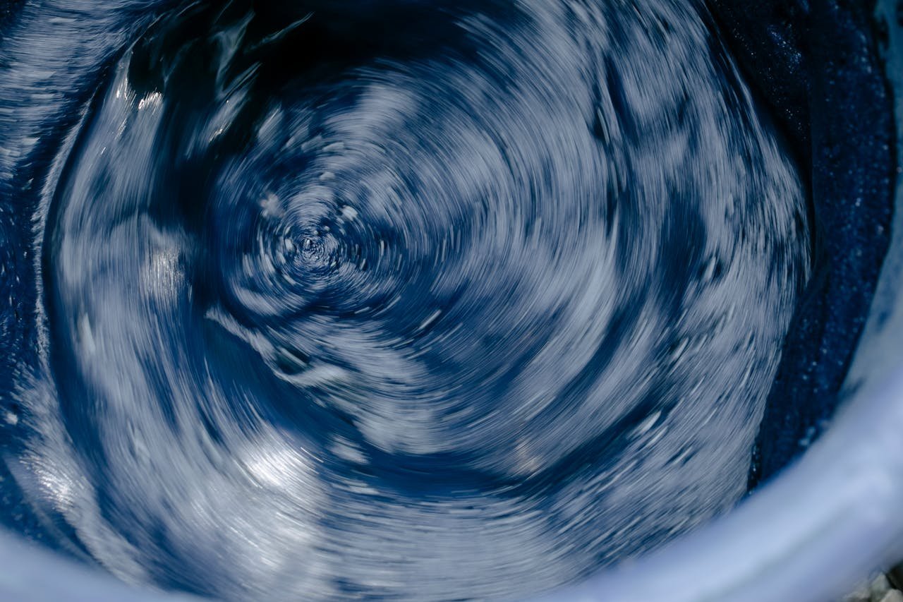 our-story Abstract blue water swirl in motion, capturing energy and flow.